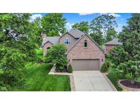 Charming brick home with a well-maintained lawn and mature trees providing ample shade at 1850 Longest Dr, Franklin, IN 46131