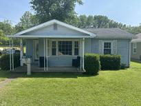 Charming single-story home with a covered front porch and well-maintained lawn at 2133 10Th St, Columbus, IN 47201