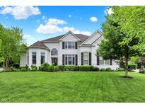 Stunning two-story white brick home with lush lawn, manicured landscaping, and beautiful curb appeal at 2535 Dawn Ridge Dr, Westfield, IN 46074