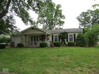 Charming single story home featuring a well-manicured lawn and a quaint front porch at 2825 Lucas Way, Columbus, IN 47203