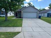 Charming single-story home featuring a well-maintained lawn and a two-car attached garage at 3861 Candle Berry Dr, Indianapolis, IN 46235