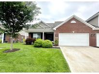 Charming single-story brick home featuring an attached garage and well-maintained landscaping at 4209 Switchgrass Way, Indianapolis, IN 46237