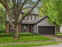 Charming two-story home with gray siding, brick accents, and a well-manicured front yard at 4736 Rocky Knob Ln, Indianapolis, IN 46254