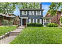 Charming two-story home featuring a classic design, well-manicured lawn and inviting entryway at 519 Woodruff Place Middle Dr, Indianapolis, IN 46201