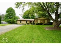 Charming single-story home with stone facade, mature trees, and well-manicured lawn at 5331 Birch Ln, Greenwood, IN 46143