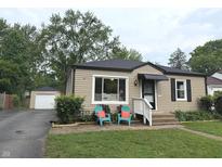 Charming single-story home featuring tidy landscaping and detached garage at 5348 Crittenden Ave, Indianapolis, IN 46220
