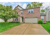 Charming two-story brick home with a well-maintained lawn and a two-car garage at 5737 Arlington Dr, Plainfield, IN 46168