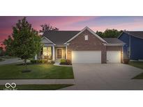 Charming brick home with a two-car garage, lush lawn, and inviting front porch at 589 Viking Warrior Blvd, Westfield, IN 46074