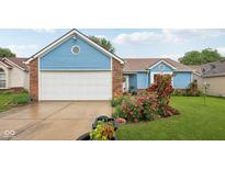 Charming single Gathering home with blue siding, brick accents, and a well-manicured front yard with roses at 6627 Cobden Ct, Indianapolis, IN 46254