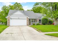 Charming single-story home with a well-manicured lawn and a welcoming porch at 6737 Raritan Dr, Indianapolis, IN 46221