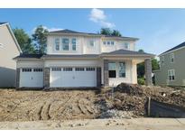 New two-story home with a three-car garage and stone accents awaiting landscaping at 6761 Seabiscuit Rd, Whitestown, IN 46075