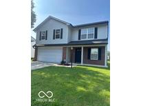 Two-story home featuring a two-car garage and well-maintained lawn at 7549 Stockard St, Indianapolis, IN 46239