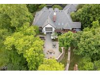 Stunning aerial view of a luxurious home with a stone patio, outdoor seating, and lush landscaping at 8301 Reef Ct, Indianapolis, IN 46236
