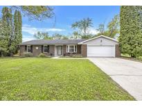 Charming brick home with a well-manicured lawn and a two-car garage at 9010 Deer Run Dr, Indianapolis, IN 46256
