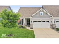 Charming home exterior with a well-manicured lawn and a two-car garage at 104 Perlican Dr, Cicero, IN 46034
