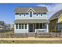 Charming two-story home with light blue siding, inviting front porch, and well-maintained landscaping at 10479 Dusty Rose Dr, Zionsville, IN 46077