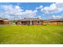 Charming brick ranch home with a well-maintained lawn and inviting front entrance at 105 Golf Club Rd, Anderson, IN 46011
