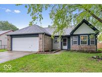 Charming single-Gathering home featuring a 2-car garage and a well-maintained lawn at 12277 E Harvest Glen Dr, Indianapolis, IN 46229