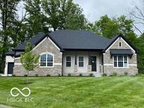 Charming single-story home featuring stone accents, manicured lawn, and a covered front porch at 12511 Lowery Way, Fishers, IN 46037