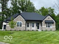 Charming single-story home with stone accents, well-manicured lawn, and professional landscaping at 12511 Lowery Way, Fishers, IN 46037