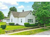 Charming single-story home featuring mature trees, green lawn, and concrete retaining wall at 1331 S 9Th St, Noblesville, IN 46060