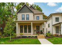 Charming two-story home featuring a welcoming front porch, manicured lawn, and classic architectural details at 1818 Central Ave, Indianapolis, IN 46202