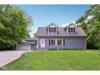 Charming two-story home boasts dormer windows, light blue siding, and a well-manicured lawn at 3713 W 98Th St, Carmel, IN 46032