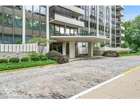 Image of the exterior of the Tarkington Tower building with stone-paved entry and manicured landscaping at 4000 N Meridian St # Apt 11D, Indianapolis, IN 46208