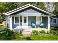 Charming home with a welcoming front porch, manicured lawn, and inviting curb appeal at 4926 Crittenden Ave, Indianapolis, IN 46205