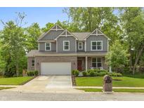 Beautiful two-story home with a brick and gray siding facade, two-car garage, and a landscaped front yard at 527 Macintosh Ln, Danville, IN 46122