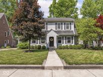 Charming two-story home with a well-manicured lawn and a symmetrical facade with classic shutters at 5342 Central Ave, Indianapolis, IN 46220