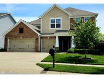Charming two-story home with a three car garage, brick accents, and well-maintained landscaping at 5379 Marigold Dr, Plainfield, IN 46168