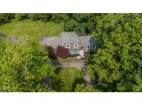 Aerial view of a charming home with a well-manicured lawn and mature trees at 5506 Kessler Blvd N Dr, Indianapolis, IN 46228
