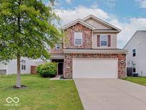 Charming two-story home with brick accents, a well-maintained lawn, and a two-car garage at 5768 Blue Sky Dr, Whitestown, IN 46075