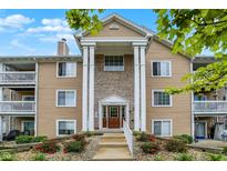 Charming condo with classic architectural design and beautiful landscaping with colorful flowerbeds at 6518 Jade Stream Ct # 312, Indianapolis, IN 46237