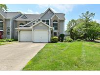 Charming two-story home features a two-car garage and well-manicured lawn and attractive curb appeal at 7529 Oceanline Dr, Indianapolis, IN 46214