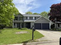 Charming two-story home featuring a two-car garage and a well-maintained front lawn at 8075 Cardinal E Cv, Indianapolis, IN 46256