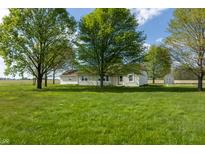 Ranch style home with large front yard and mature trees offering shade and curb appeal at 8370 State Road 236, North Salem, IN 46165