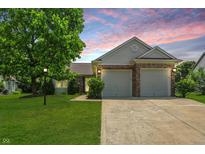 Charming home featuring brick accents, a two-car garage, and a well-manicured lawn at 863 Lionshead Ln, Greenwood, IN 46143