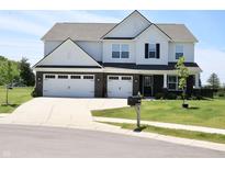 Charming two-story home featuring a three-car garage, well-manicured lawn, and inviting curb appeal at 9640 Katana Cir, Fishers, IN 46040