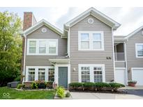 Charming two-story home with gray siding, manicured landscaping, and inviting entrance, creating excellent curb appeal at 9743 Herons Cv, Carmel, IN 46280