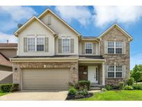 Charming two-story home featuring a brick and vinyl exterior, attached garage, and landscaped front yard at 11849 Traymoore Dr, Fishers, IN 46038