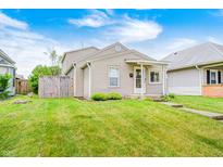Charming single-Gathering home featuring a well-maintained lawn and a cozy, inviting front porch at 148 S 3Rd Ave, Beech Grove, IN 46107