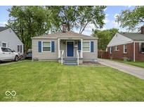 Charming single-story home with blue shutters and a well-manicured front lawn at 1907 N Drexel Ave, Indianapolis, IN 46218