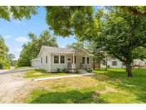 Charming single-story home with a well-manicured lawn and inviting front porch at 203 S 17Th Ave, Beech Grove, IN 46107