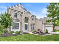 Charming two-story home with a brick facade, well-manicured lawn, and inviting curb appeal at 2070 Mustang Chase Dr, Carmel, IN 46074