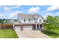 Charming two-story home boasts a brick facade, attached two-car garage, and manicured lawn at 2337 Hanover Rd, Brownsburg, IN 46112