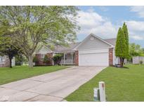 Charming single-story home with a well-manicured lawn and attached two-car garage at 374 Pomona Ct, Greenfield, IN 46140