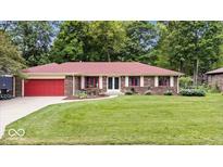 Charming brick ranch home with a well-manicured lawn and a welcoming red front door at 434 Verwood Ct, Indianapolis, IN 46234