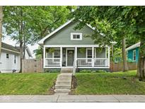Charming home featuring a cozy front porch, inviting curb appeal, and lovely landscaping at 4414 Winthrop Ave, Indianapolis, IN 46205